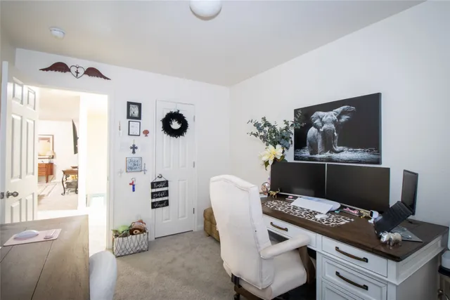 a living room with furniture and wall paintings