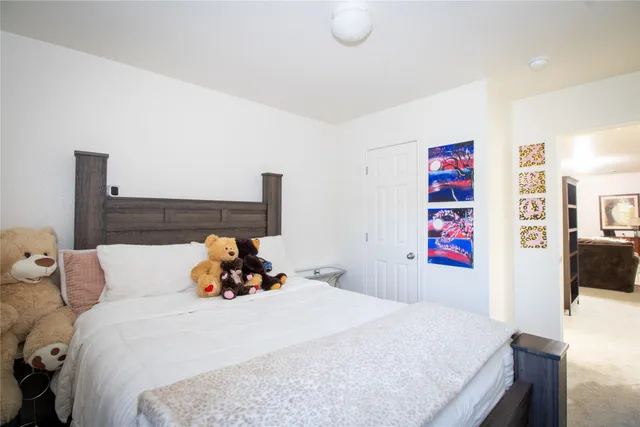 a bedroom with bed and a book shelf