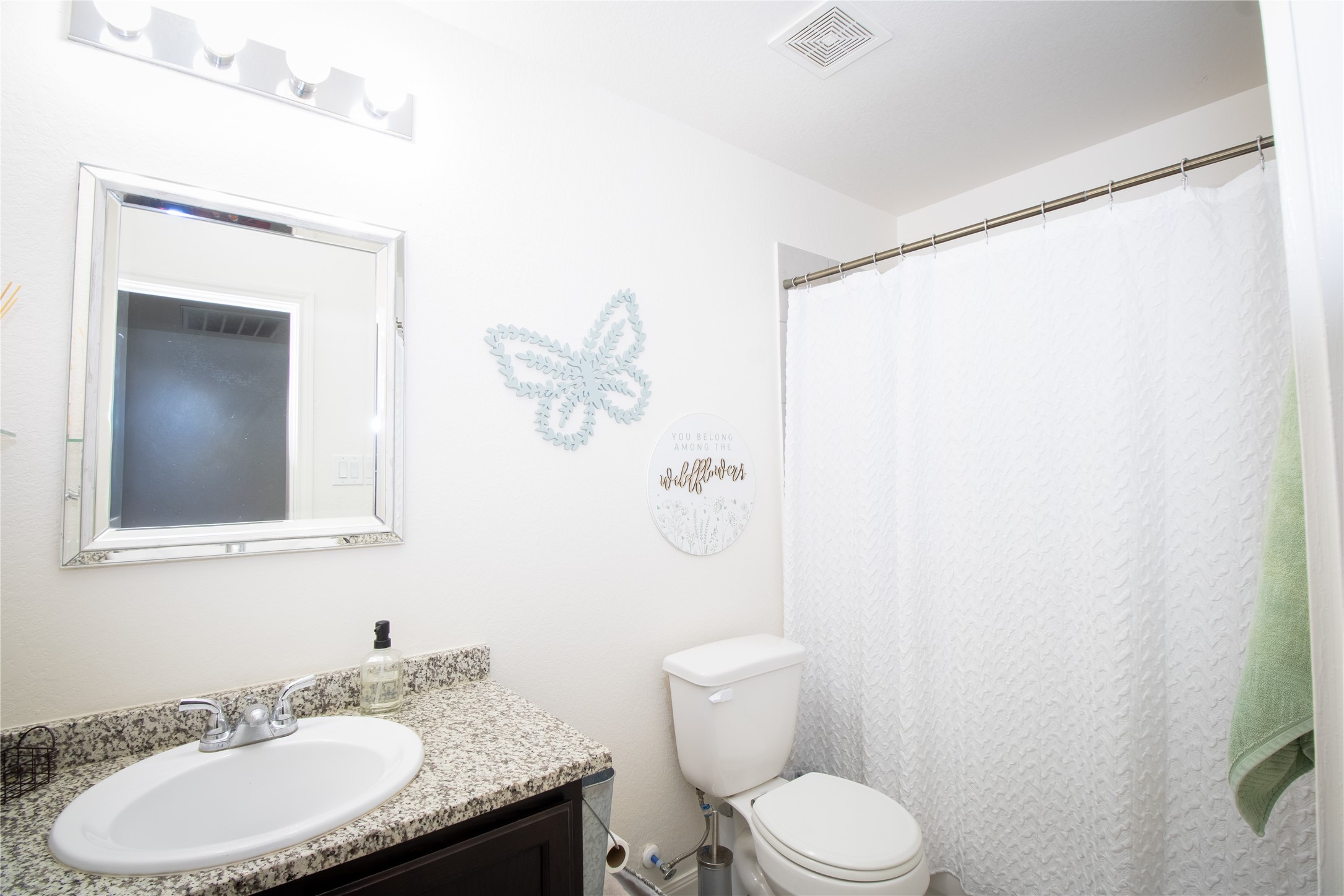 15583 Arrowhead Loop West Willis, TX 77378 - Photo 18 of 21 a bathroom with a granite countertop sink toilet and a mirror