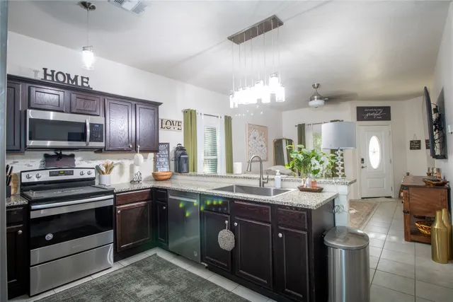 a kitchen with a sink stove and microwave