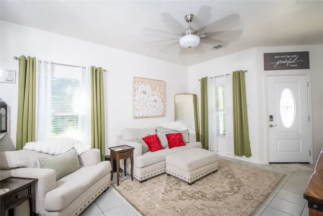 a living room with furniture and a large window