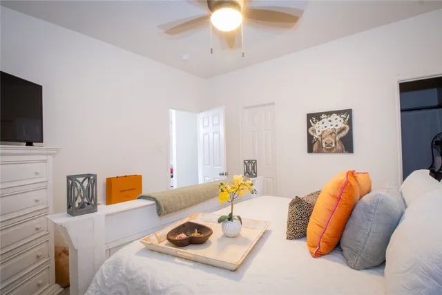 a bedroom with a bed and a flat screen tv