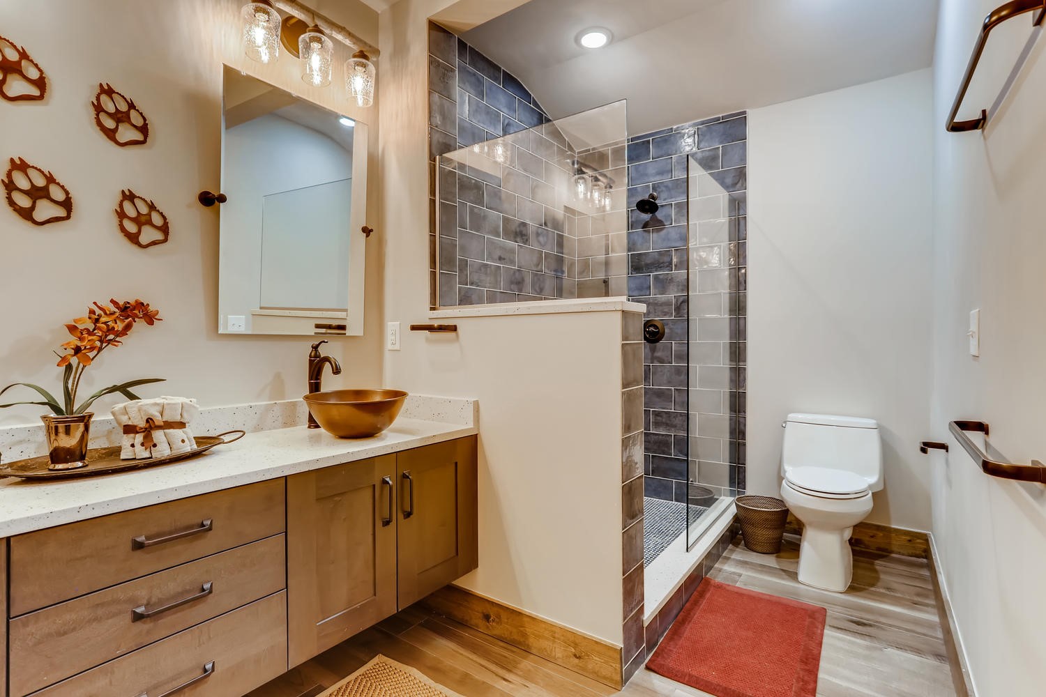 125 Lake Ridge Circle, Unit 1866 Keystone, CO 80435 - Photo 26 of 42 a bathroom with a granite countertop sink a toilet and a shower