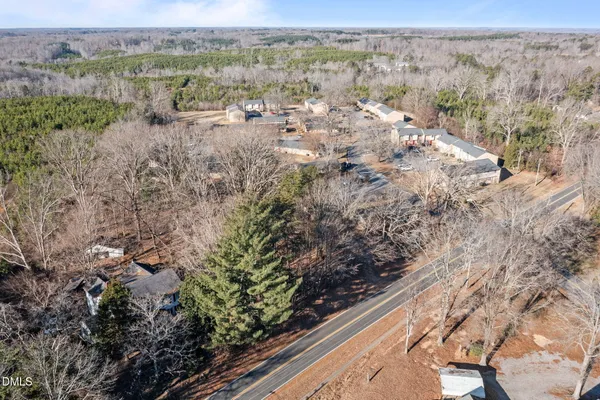 a view of a forest with wooden fence