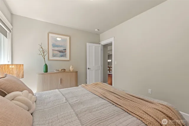 a dining room with wooden floor a chandelier a glass table and chairs