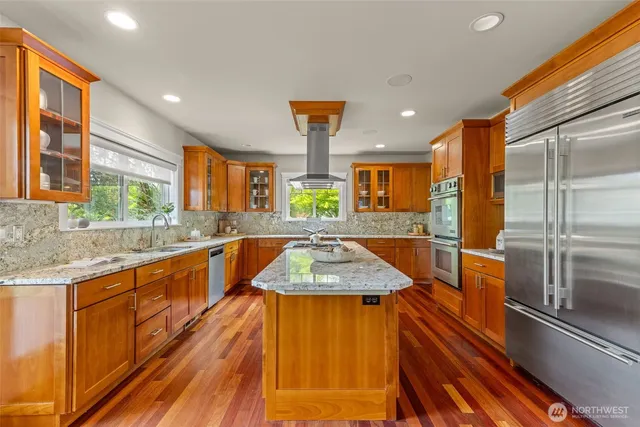 a kitchen with a sink a counter top space and living room area