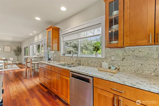 a kitchen with stainless steel appliances granite countertop a sink stove and cabinets