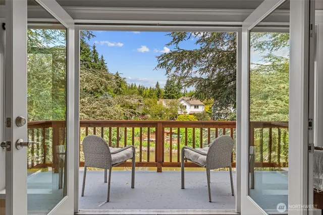 a bathroom with a granite countertop sink a toilet a mirror and shower