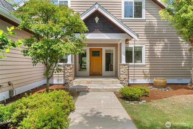 a front view of a house with a garden