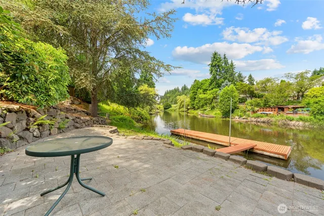 a view of a lake with a table and chairs