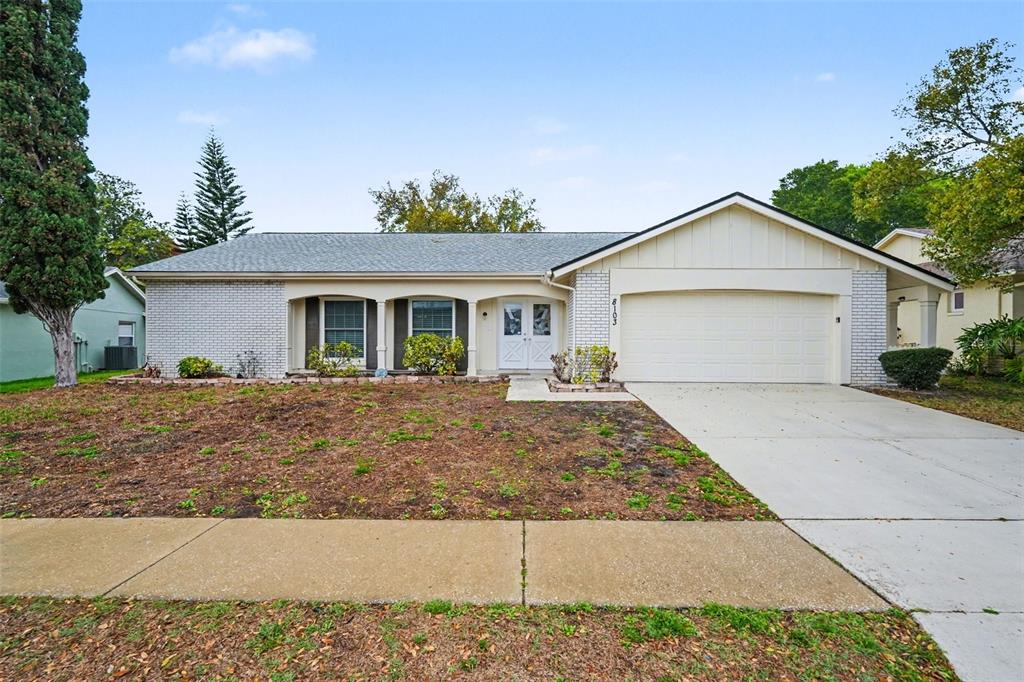 8103 Roxboro Drive Hudson, FL 34667 - Photo 1 of 28 a front view of house with yard and trees around