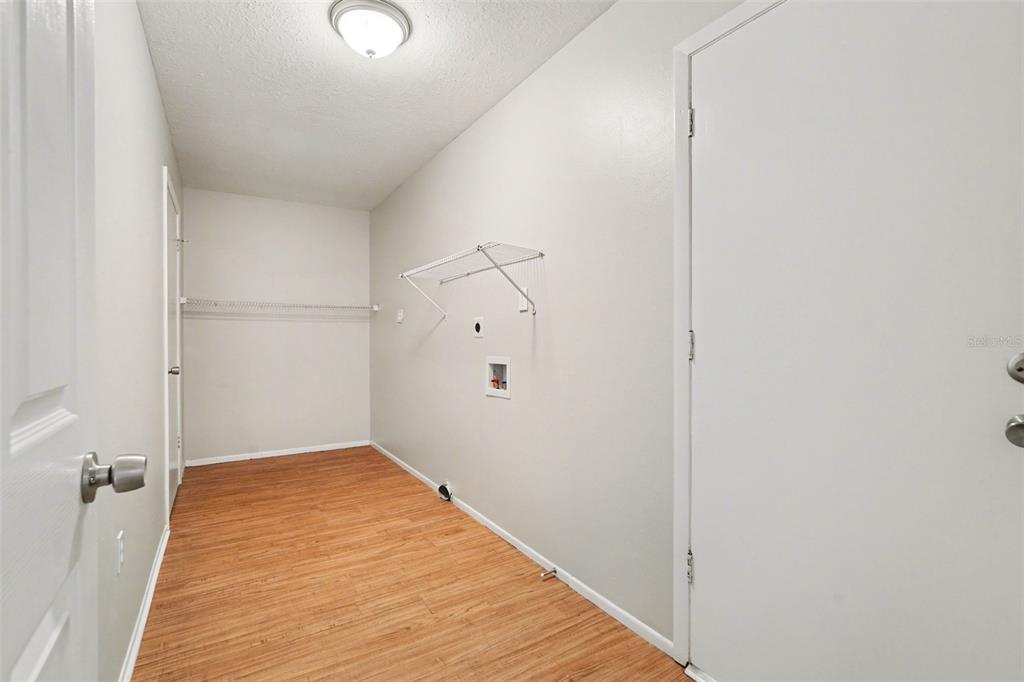 8103 Roxboro Drive Hudson, FL 34667 - Photo 13 of 28 a view of a room with wooden floor and white walls