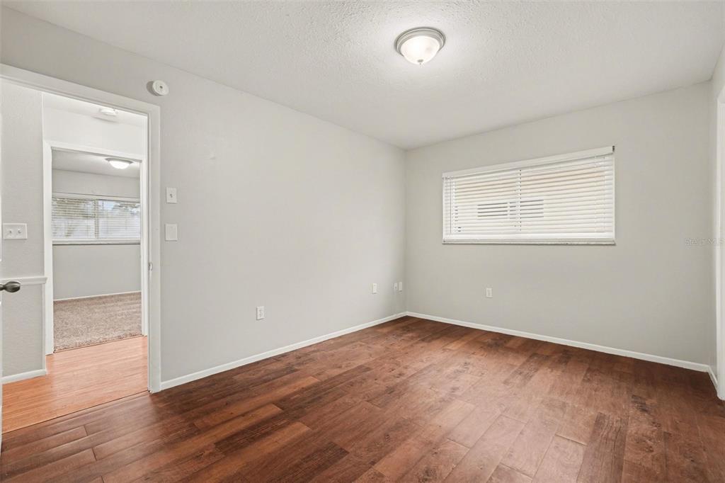 8103 Roxboro Drive Hudson, FL 34667 - Photo 20 of 28 an empty room with wooden floor and windows