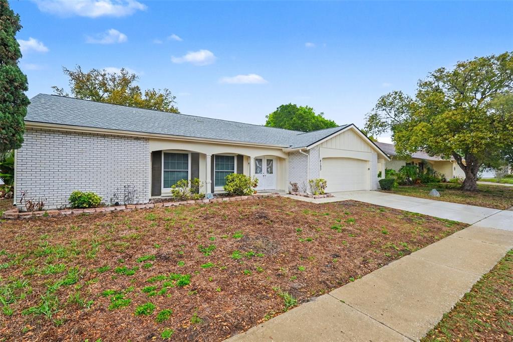 8103 Roxboro Drive Hudson, FL 34667 - Photo 2 of 28 a view of garage and yard