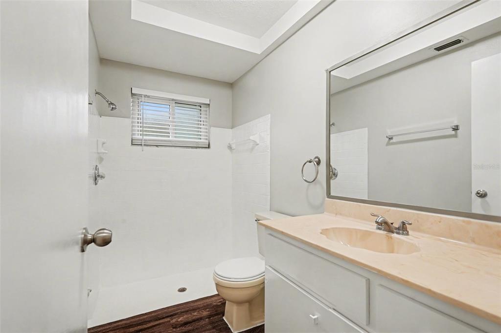 8103 Roxboro Drive Hudson, FL 34667 - Photo 22 of 28 a bathroom with a granite countertop sink toilet and shower