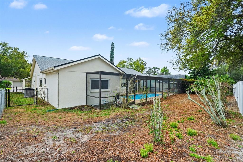 8103 Roxboro Drive Hudson, FL 34667 - Photo 26 of 28 a backyard of a house with table and chairs