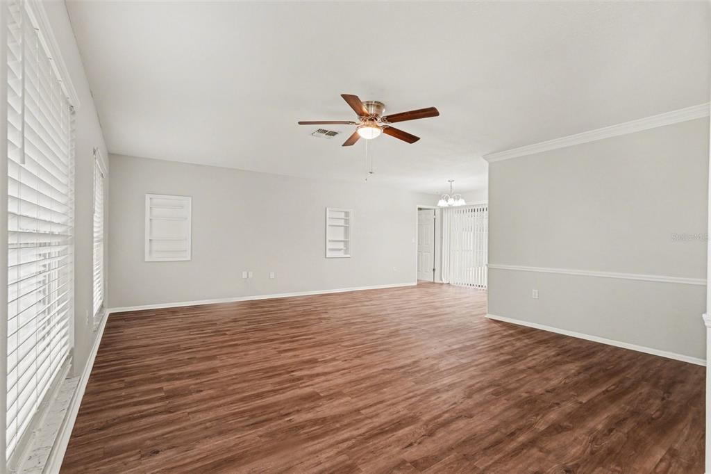 8103 Roxboro Drive Hudson, FL 34667 - Photo 3 of 28 wooden floor in an empty room with a window