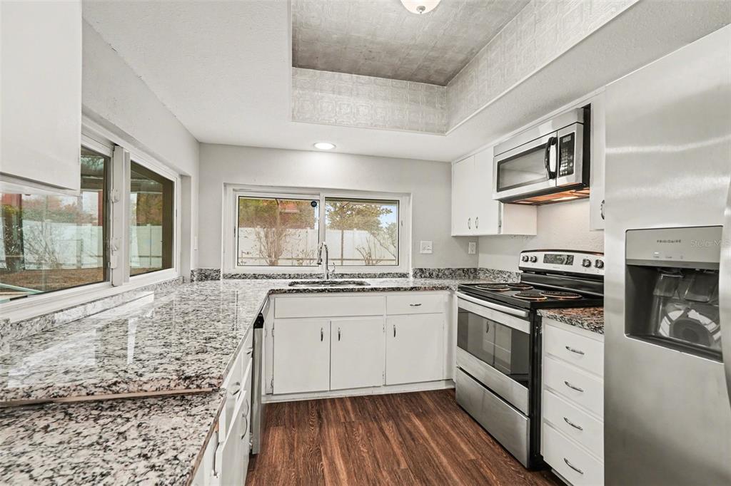 8103 Roxboro Drive Hudson, FL 34667 - Photo 6 of 28 a kitchen with stainless steel appliances granite countertop a stove and a sink