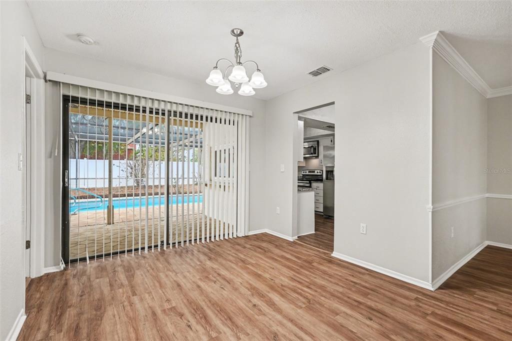 8103 Roxboro Drive Hudson, FL 34667 - Photo 9 of 28 wooden floor in an empty room with a window