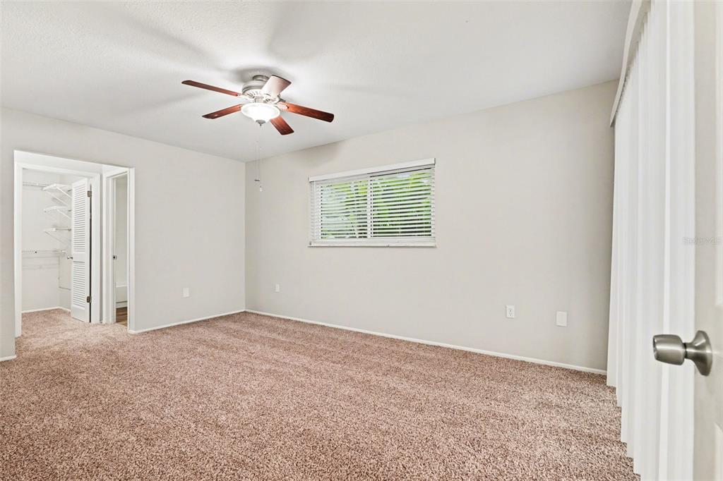 8103 Roxboro Drive Hudson, FL 34667 - Photo 10 of 28 an empty room with windows and fan