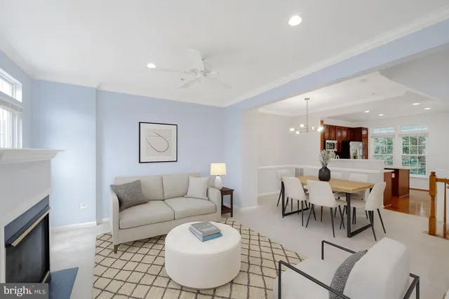 a living room with furniture and a dining table with wooden floor