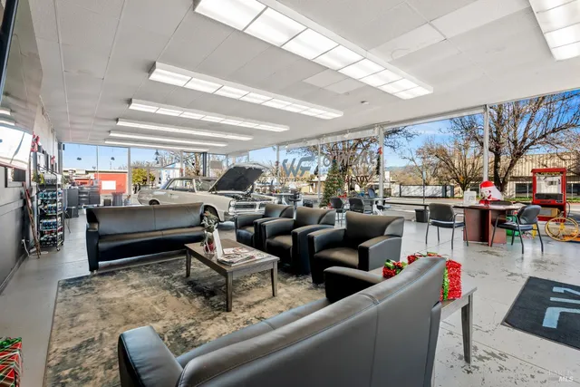 a living room with furniture and a dining table with kitchen view