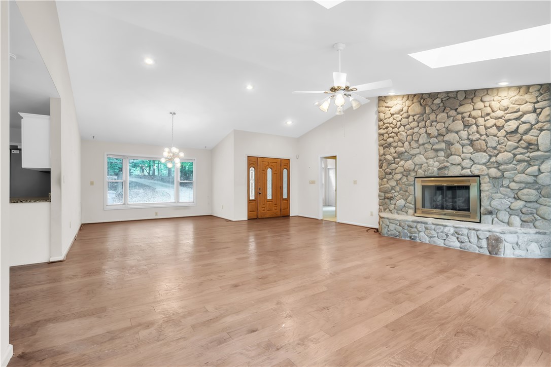 149 Inlet Pointe Drive Anderson, SC 29625 - Photo 4 of 43 Vast living area boasts vaulted ceilings, a river rock fireplace, and rich hardwood floors.