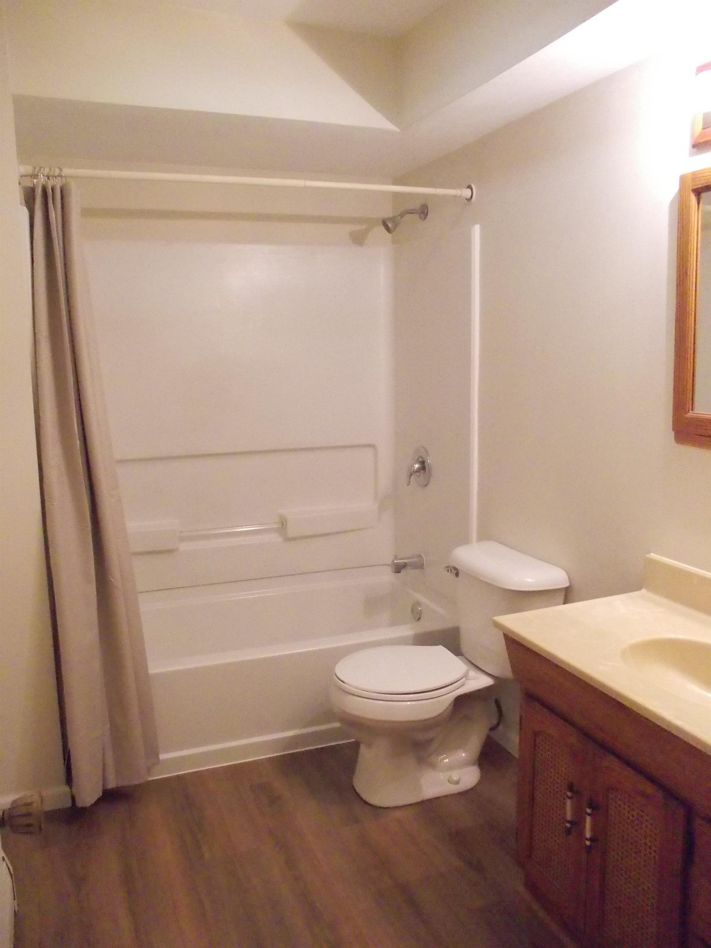 724 Taft Road Rockford, IL 61109 - Photo 12 of 19 a bathroom with a toilet a sink and a shower