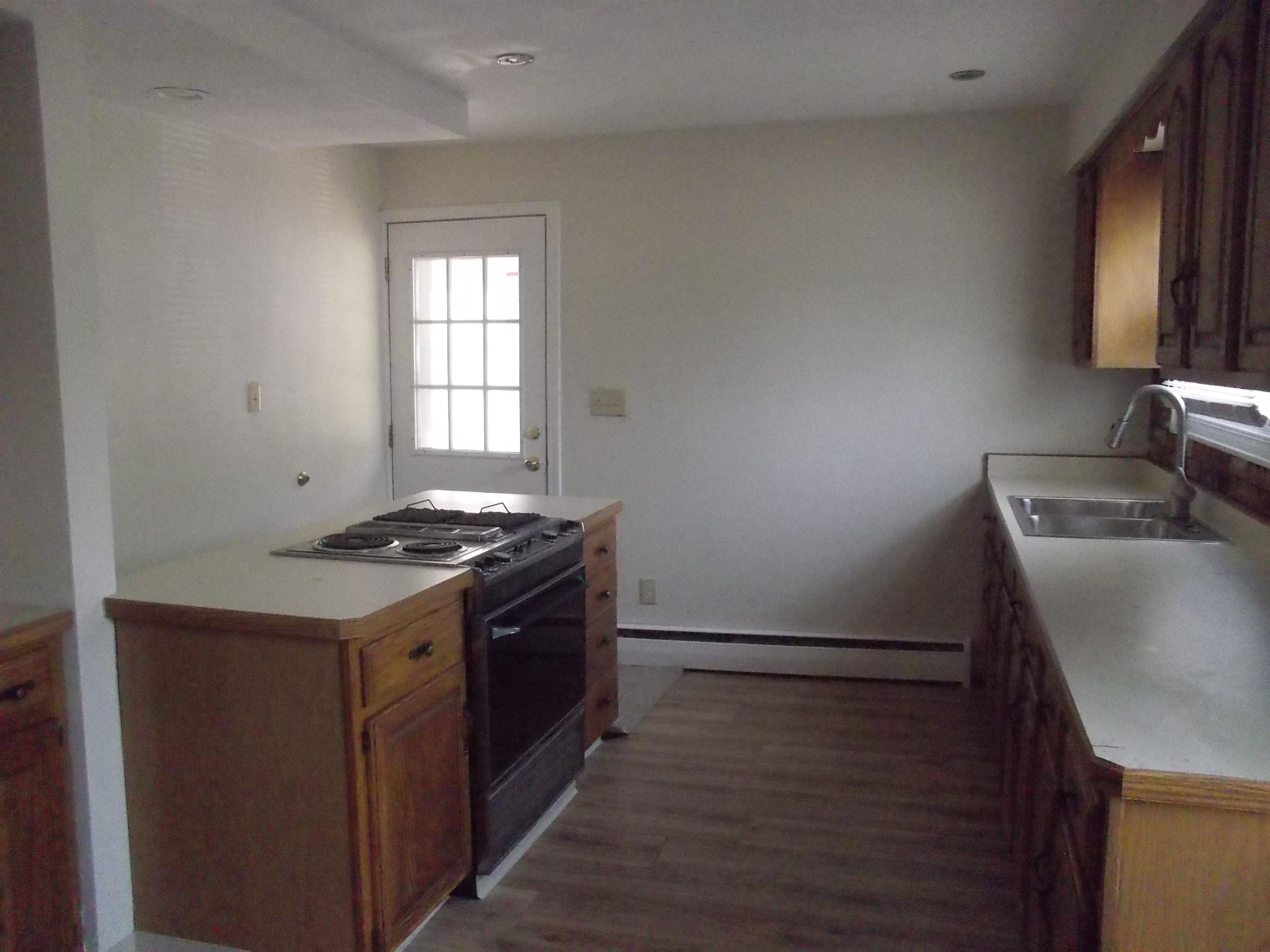 724 Taft Road Rockford, IL 61109 - Photo 7 of 19 a kitchen with granite countertop a stove and a refrigerator