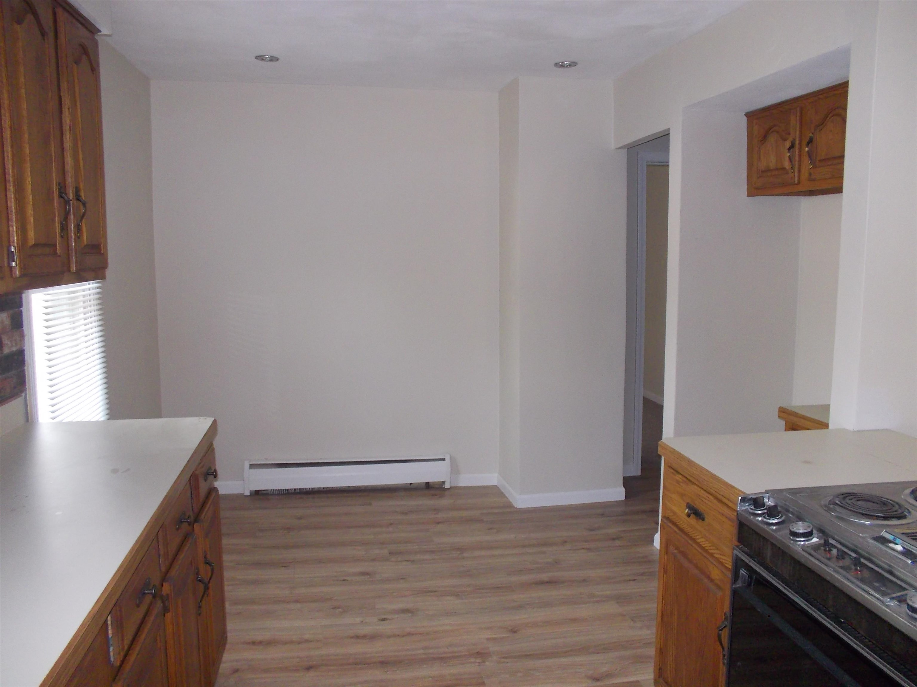 724 Taft Road Rockford, IL 61109 - Photo 8 of 19 a view of a kitchen with wooden floor and electronic appliances