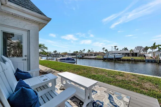 a view of a lake with couches in the patio