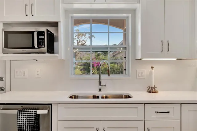 a kitchen with a sink and microwave