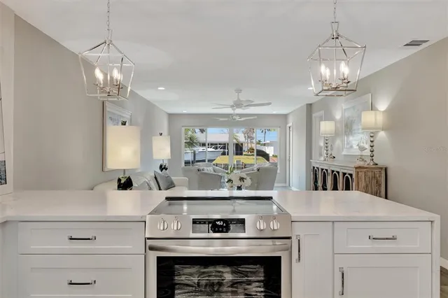 a kitchen with a stove and a chandelier