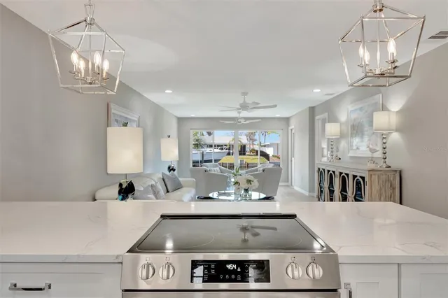 a view of a room with kitchen island stainless steel appliances table and chairs