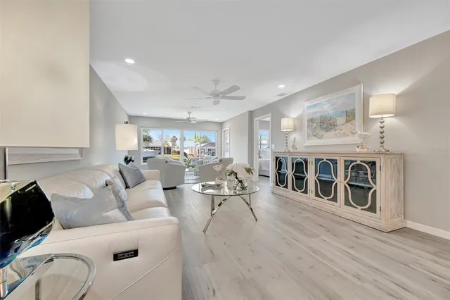 a living room with furniture wooden floor and a fireplace