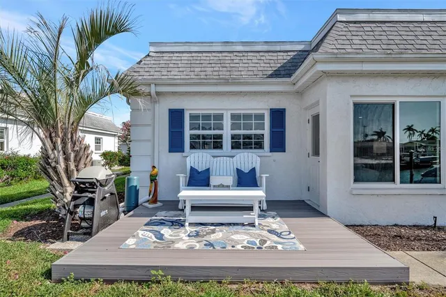 a view of a house with backyard porch and sitting area
