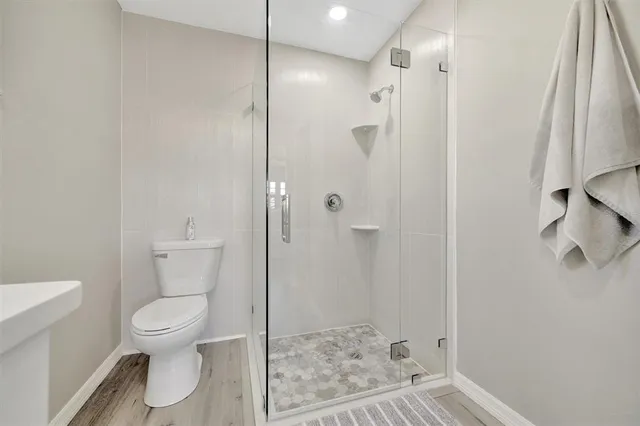 a bathroom with a toilet and a shower