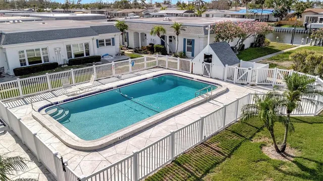 a view of a pool with chairs