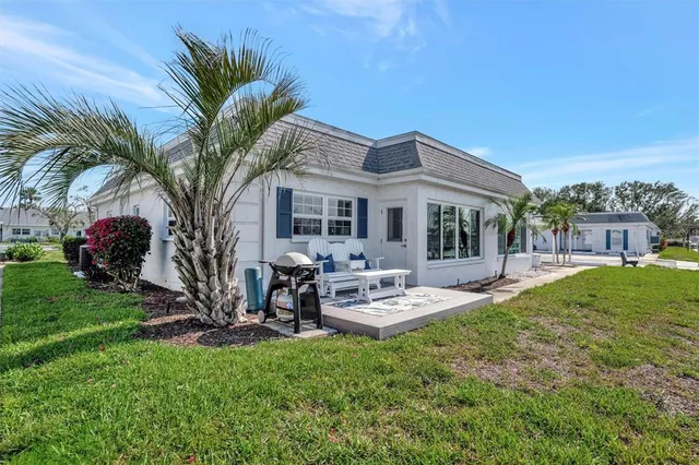 a view of a house with backyard porch and sitting area