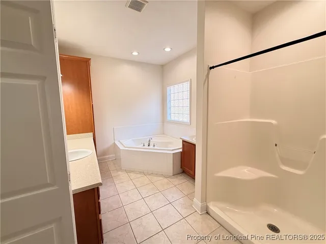 a bathroom with a bathtub and a shower