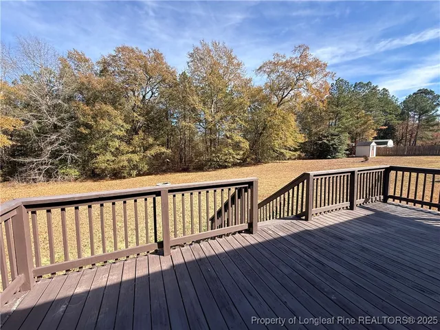 a balcony with wooden floor and fence