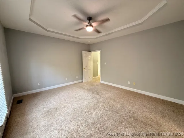 a view of an empty room with a ceiling fan