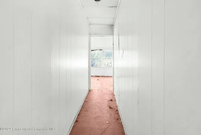 a view of a refrigerator a sink and cabinets