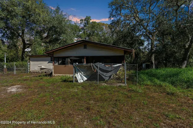 a front view of house with a garden