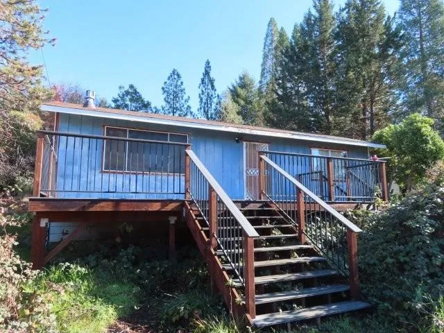 a view of balcony with wooden floor and fence