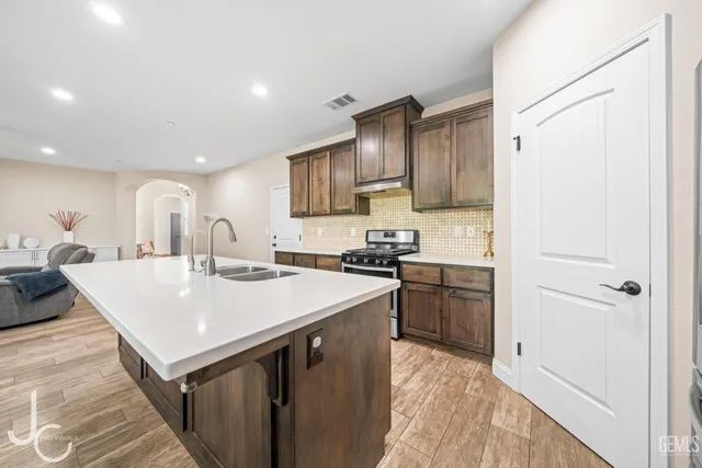 a kitchen with a sink a stove a refrigerator and a refrigerator