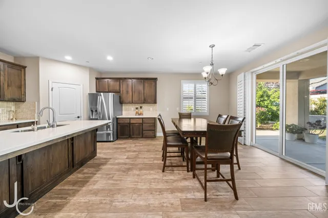 a large kitchen with a table and chairs