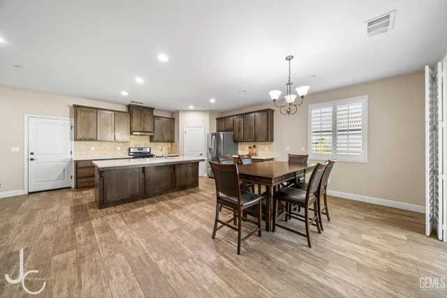 a view of a dining room with furniture and chandelier