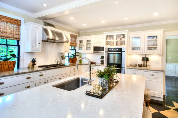 a kitchen with stainless steel appliances a stove a sink and a refrigerator