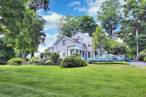 a front view of a house with a garden